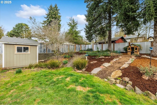 view of yard with a storage shed, an outdoor structure, and a fenced backyard