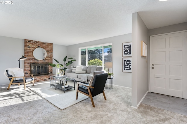 carpeted living room featuring a brick fireplace and a textured ceiling