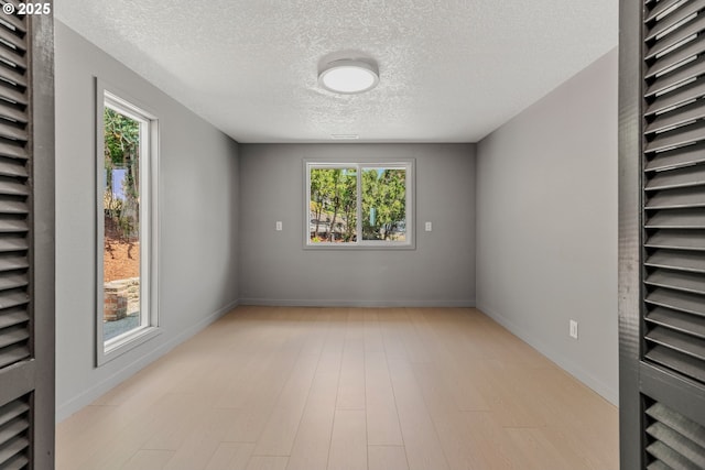 8318 SE Middle Way, Vancouver, WA 98664 - spare room featuring a textured ceiling, plenty of natural light, and light wood-style flooring