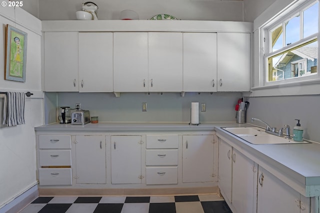 2869 SE Sherman St, Portland, OR 97214 - kitchen with light floors, light countertops, and white cabinetry