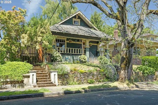 2869 SE Sherman St, Portland, OR 97214 - view of front of home with stairway, covered porch, and roof with shingles
