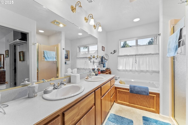 bathroom with a sink, a bath, a shower stall, and double vanity