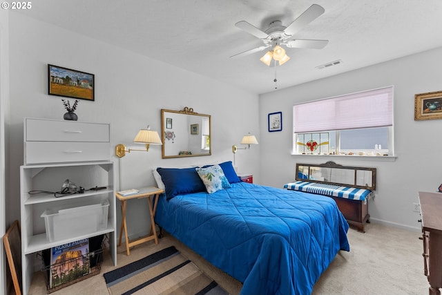 carpeted bedroom with visible vents, baseboards, a textured ceiling, and ceiling fan