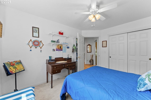 bedroom featuring a closet, baseboards, a ceiling fan, and light colored carpet