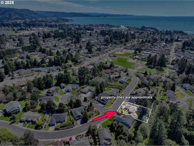 birds eye view of property featuring a water view and a residential view