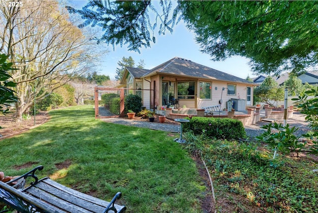 back of property with a yard and a wooden deck