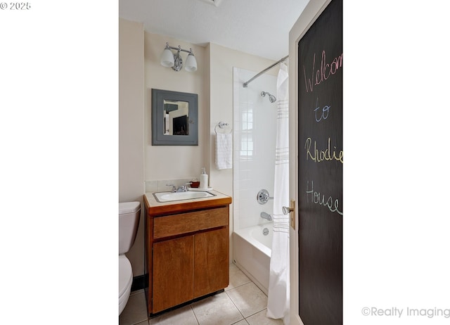 bathroom with tile patterned flooring, toilet, vanity, and bathing tub / shower combination
