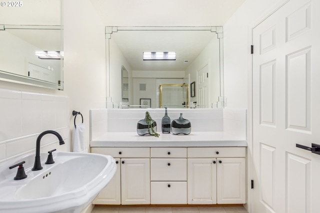 bathroom featuring sink and a shower with door