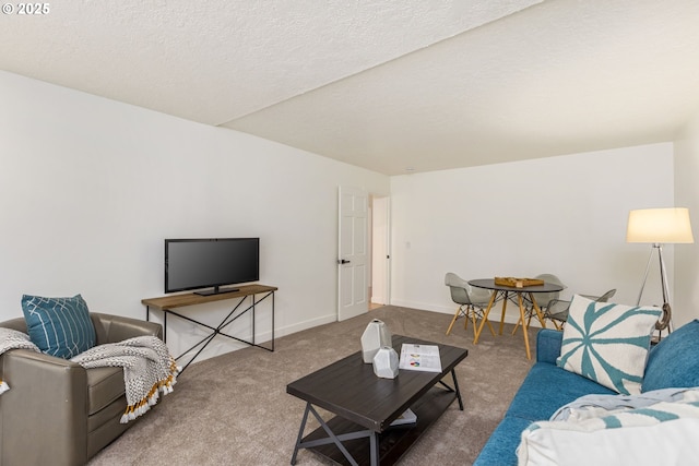 carpeted living room featuring a textured ceiling