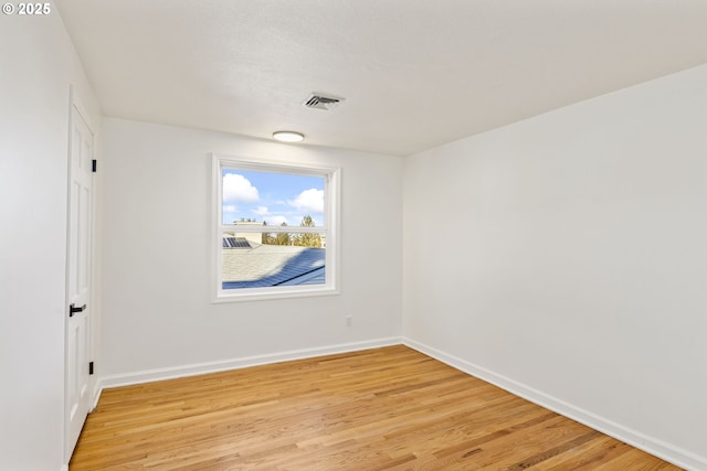 unfurnished room with light hardwood / wood-style floors and a textured ceiling