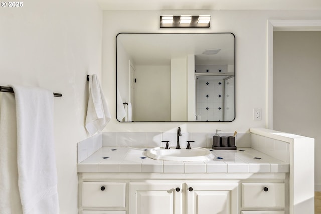 bathroom featuring vanity and a shower