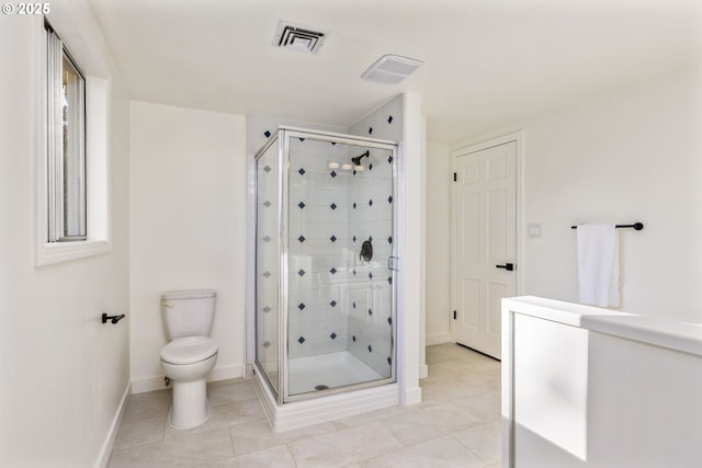 bathroom featuring tile patterned flooring, an enclosed shower, and toilet