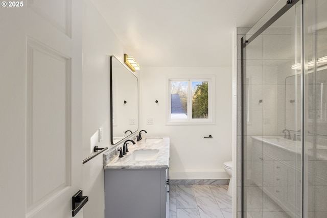 bathroom with a shower with door, vanity, and toilet