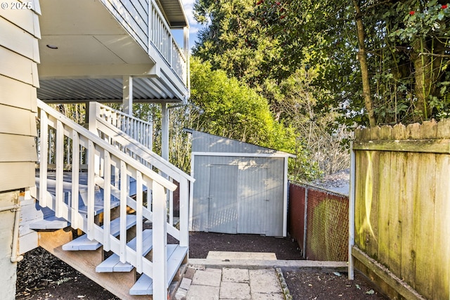 view of side of home with a storage shed