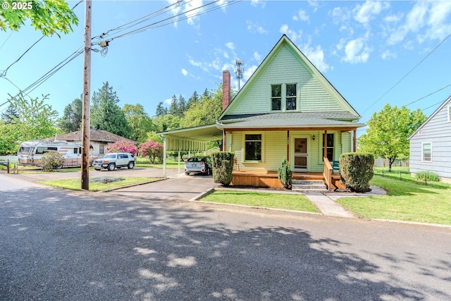 125 Clark St, Saint Helens, OR 97051 - bungalow featuring a front lawn, an attached carport, a porch, a chimney, and driveway