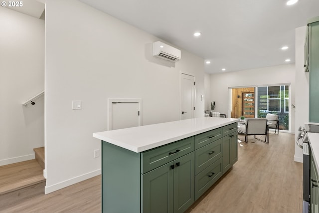 kitchen featuring a wall mounted AC, a center island, and green cabinetry