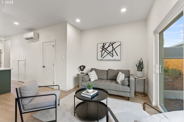 living room with a wall mounted AC and light wood-type flooring