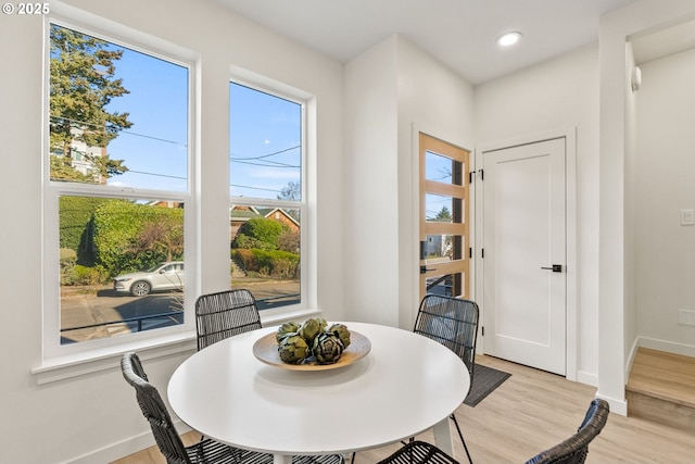 dining space featuring a healthy amount of sunlight and light hardwood / wood-style floors