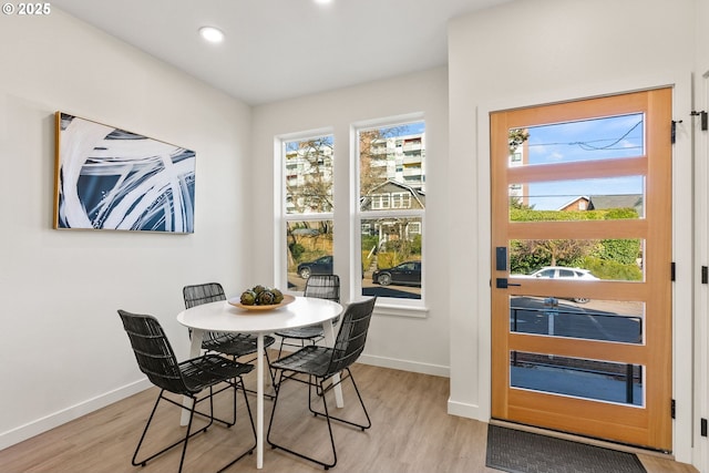 dining space with light hardwood / wood-style flooring