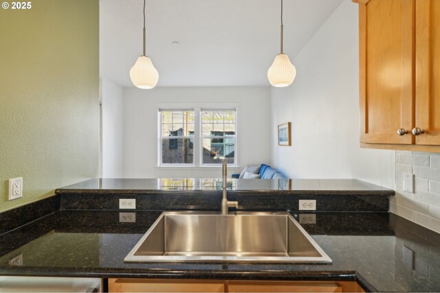 727 SE 33rd Pl Unit 21, Portland, OR 97214 - kitchen with a sink, decorative light fixtures, tasteful backsplash, and dark stone countertops