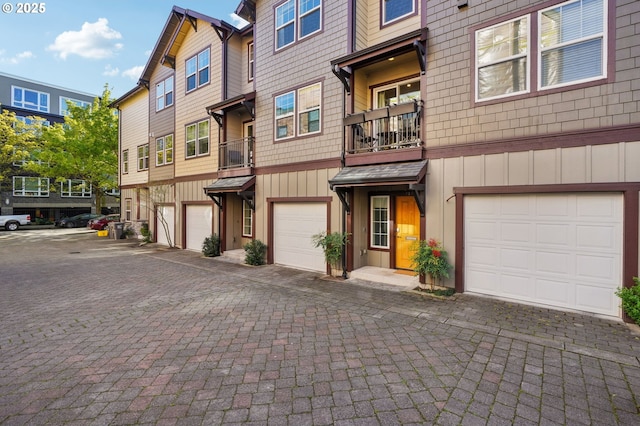 727 SE 33rd Pl Unit 21, Portland, OR 97214 - view of front of house featuring a garage, driveway, and board and batten siding