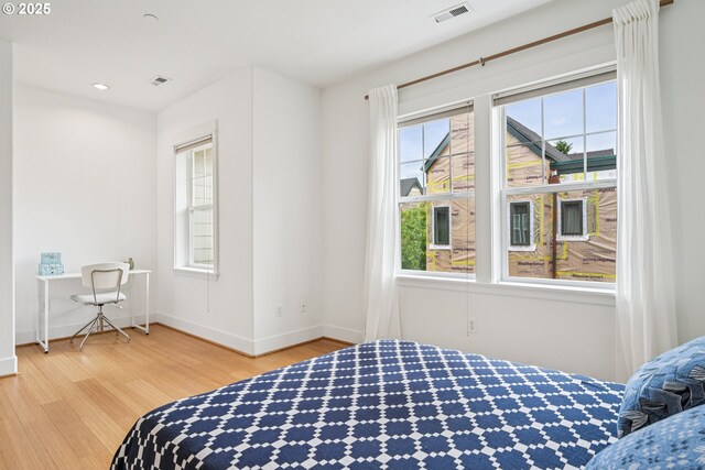 727 SE 33rd Pl Unit 21, Portland, OR 97214 - bedroom with wood finished floors, baseboards, and recessed lighting