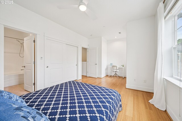 727 SE 33rd Pl Unit 21, Portland, OR 97214 - bedroom with light wood-type flooring, baseboards, ensuite bathroom, ceiling fan, and a closet