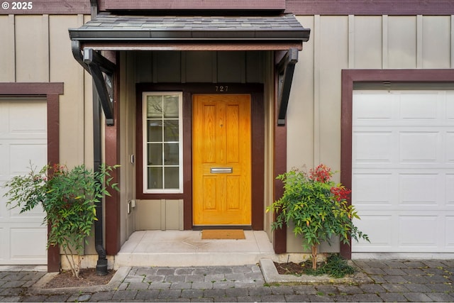 727 SE 33rd Pl Unit 21, Portland, OR 97214 - doorway to property with board and batten siding and a garage
