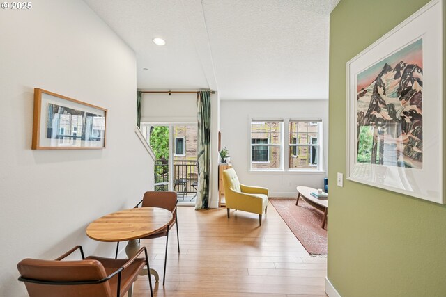 727 SE 33rd Pl Unit 21, Portland, OR 97214 - living area featuring wood finished floors, recessed lighting, baseboards, and a textured ceiling