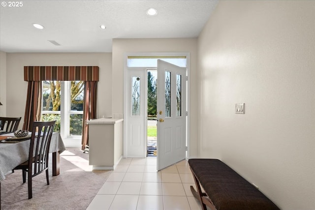 entrance foyer with recessed lighting, visible vents, a textured ceiling, and light tile patterned flooring