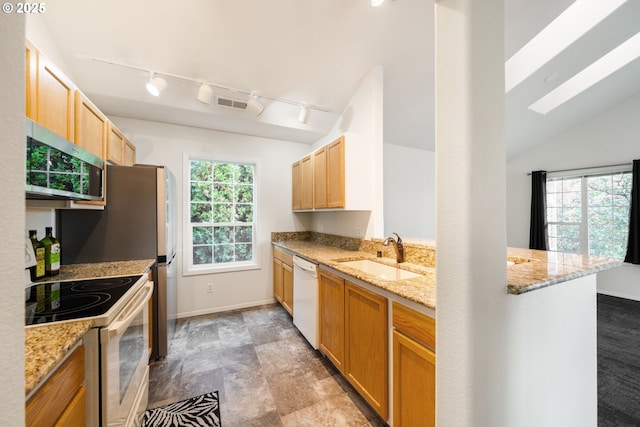 kitchen with white appliances, a sink, visible vents, and a healthy amount of sunlight