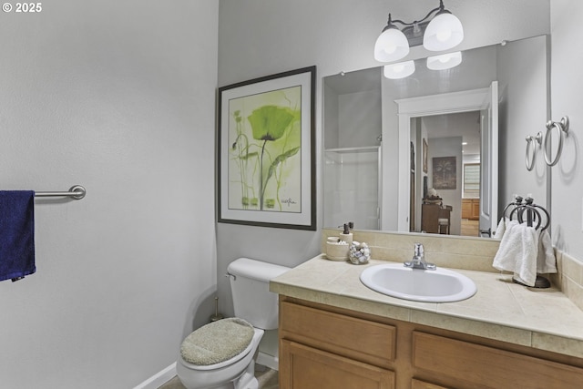 bathroom featuring vanity, toilet, and a shower with door