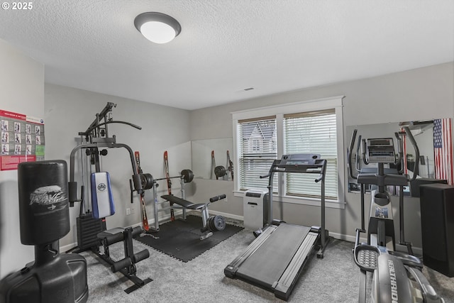 exercise room featuring a textured ceiling