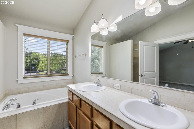 full bathroom with a sink, a garden tub, double vanity, and lofted ceiling