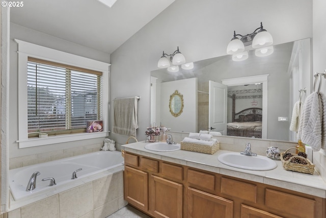 bathroom with tile patterned flooring, tiled bath, a chandelier, lofted ceiling, and vanity