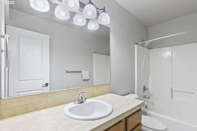 bathroom featuring toilet,  shower combination, decorative backsplash, and vanity