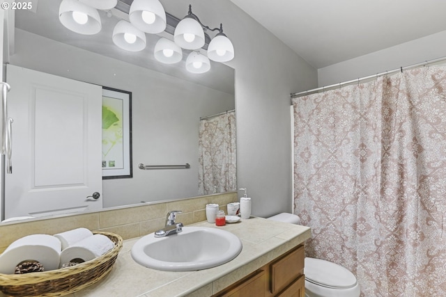 bathroom featuring backsplash, vanity, and toilet