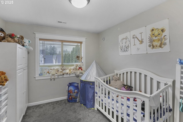 carpeted bedroom with a crib, a textured ceiling, and white refrigerator