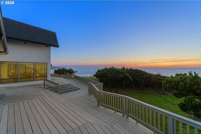 88515 Pacific Surf Ln, Bandon, OR 97411 - deck at dusk featuring a water view and a yard