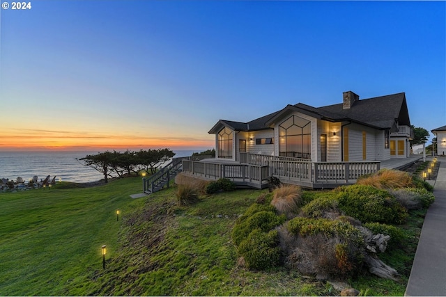 88515 Pacific Surf Ln, Bandon, OR 97411 - exterior space with a lawn, a water view, and a chimney