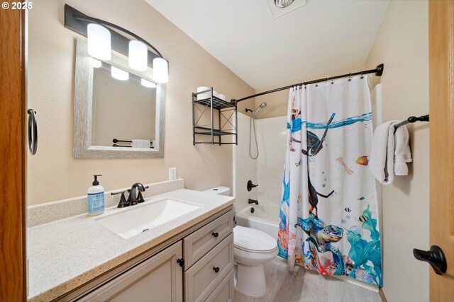 bathroom with vanity, shower / bath combo with shower curtain, toilet, and wood finished floors