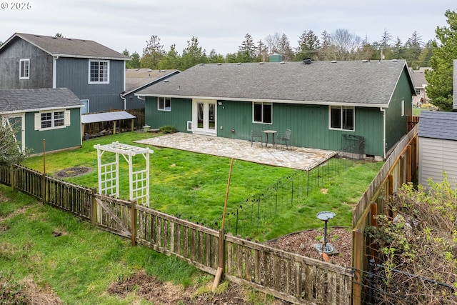 35363 Bayside Gardens Rd, Nehalem, OR 97131 - rear view of house with a patio, an outbuilding, and a shingled roof