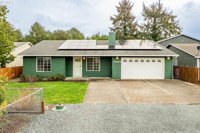 35363 Bayside Gardens Rd, Nehalem, OR 97131 - view of front facade featuring driveway, a garage, solar panels, and a chimney