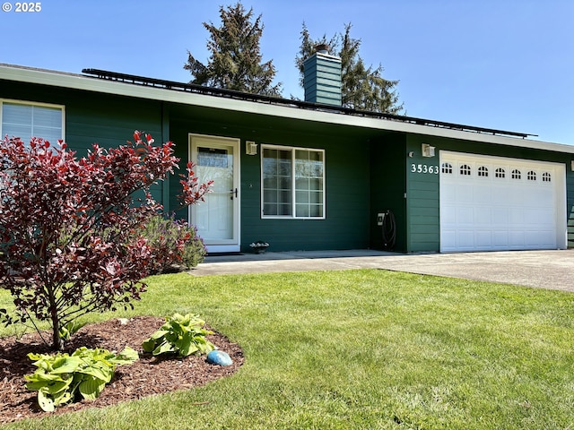 35363 Bayside Gardens Rd, Nehalem, OR 97131 - view of front facade featuring an attached garage, a front yard, a chimney, and driveway