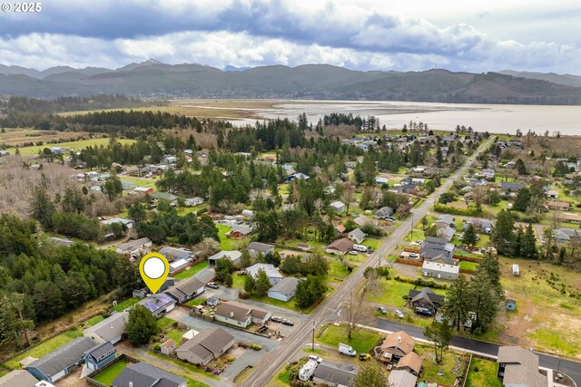 birds eye view of property with a residential view and a water and mountain view