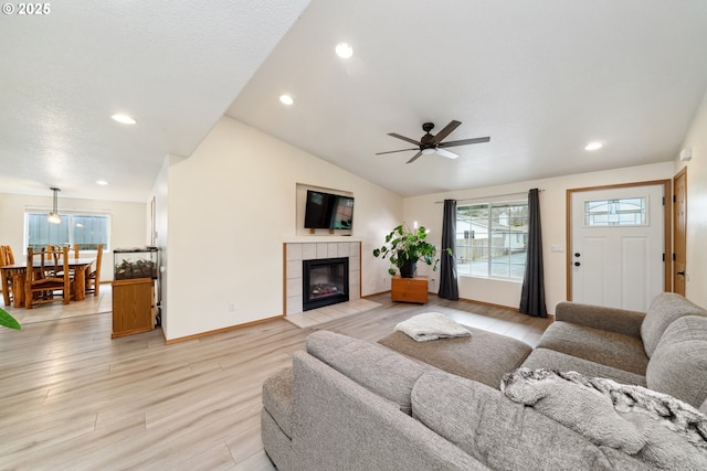 35363 Bayside Gardens Rd, Nehalem, OR 97131 - living room featuring ceiling fan, light wood-style floors, lofted ceiling, a tile fireplace, and recessed lighting