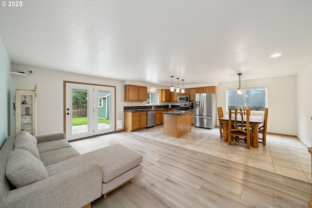 35363 Bayside Gardens Rd, Nehalem, OR 97131 - living area featuring light wood-style flooring, a textured ceiling, and recessed lighting