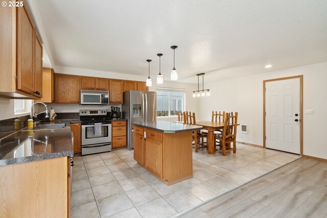 kitchen with visible vents, a center island, recessed lighting, a sink, and stainless steel appliances