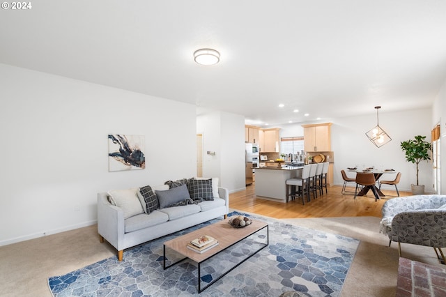 living area featuring recessed lighting, light wood-type flooring, and baseboards