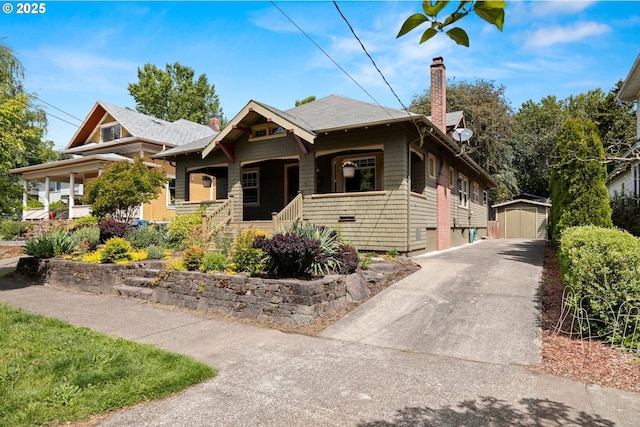 3113 SE Main St, Portland, OR 97214 - view of front of property with a chimney, a porch, a detached garage, and a shingled roof